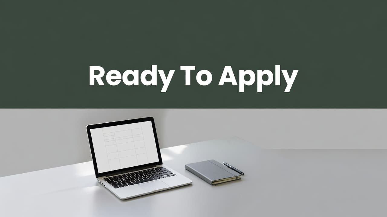 A clean workstation features a closed silver laptop and an open notebook resting on a flat surface. A bold dark-green header strip displays the white geometric text Ready To Apply.